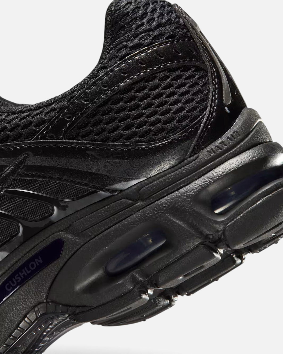 CRIUW NIKE AIR MAX MOTO 2K black sneaker showing mesh upper, metallic details, and Max Air cushioning unit.
