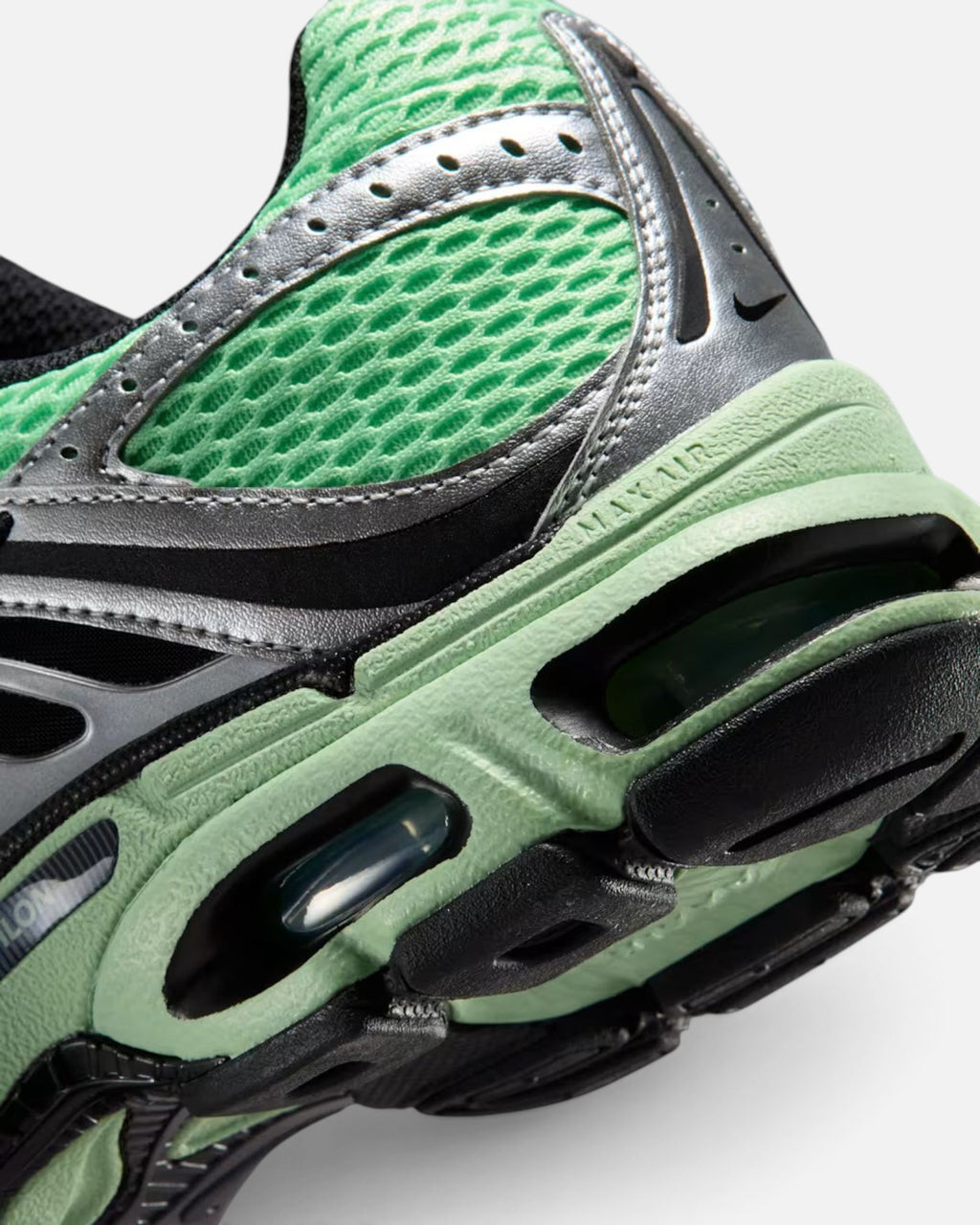 CRIUW Nike Air Max Moto 2K sneaker in illusion green with metallic silver overlays and visible Max Air cushioning.