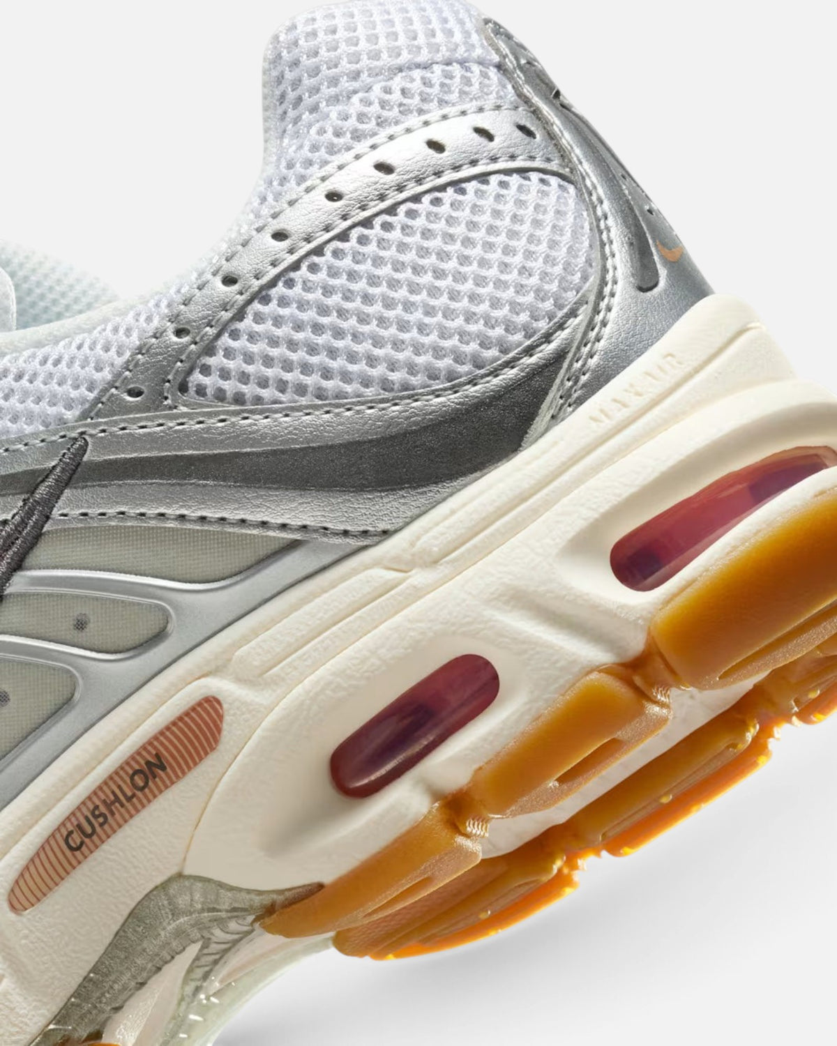 CRIUW Nike Air Max Moto 2K sneaker featuring metallic silver mesh upper, Cushlon midsole, and bronze rubber outsole.