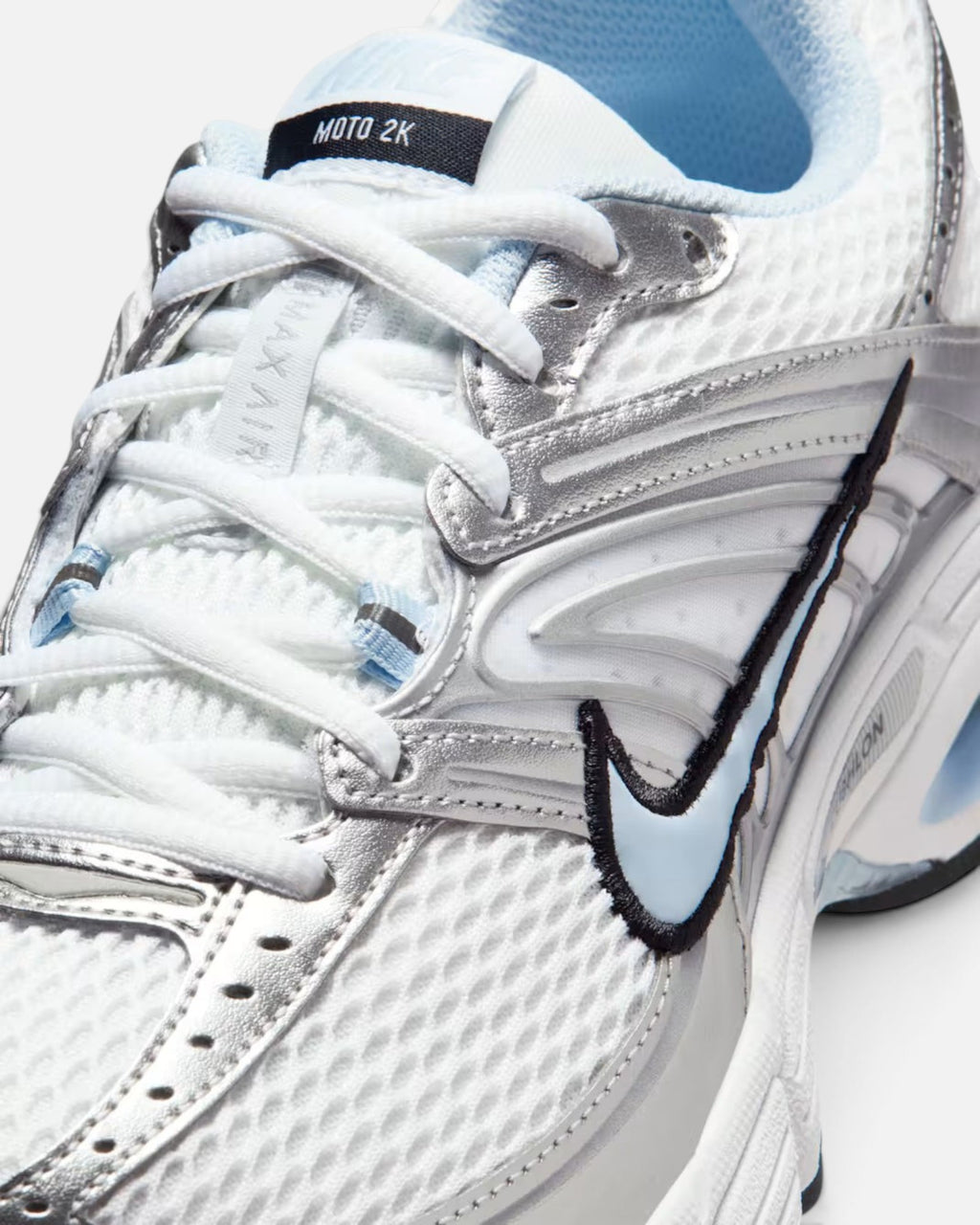CRIUW Nike Air Max Moto 2K sneakers in white and hydrogen blue with metallic silver overlays and mesh detailing.