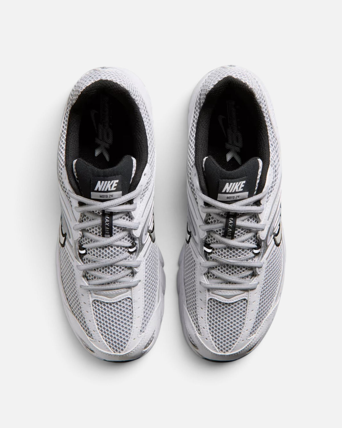 CRIUW Nike Air Max Moto 2K white performance sneakers with metallic details and breathable mesh upper, top view.