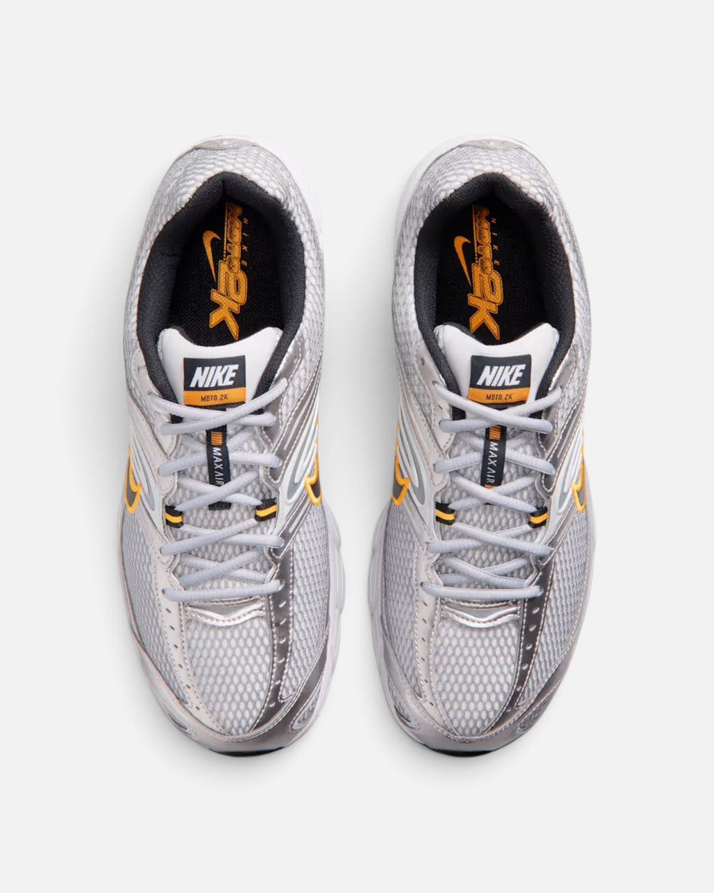 CRIUW Nike Air Max Moto 2K sneakers in wolf grey with metallic silver accents and orange detailing, top-down view.