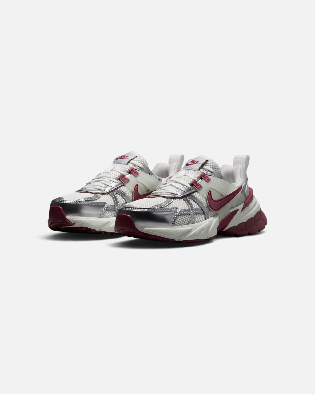 CRIUW Nike V2K Run sneakers in pink smoke and metallic silver with a chunky vintage-inspired midsole design.