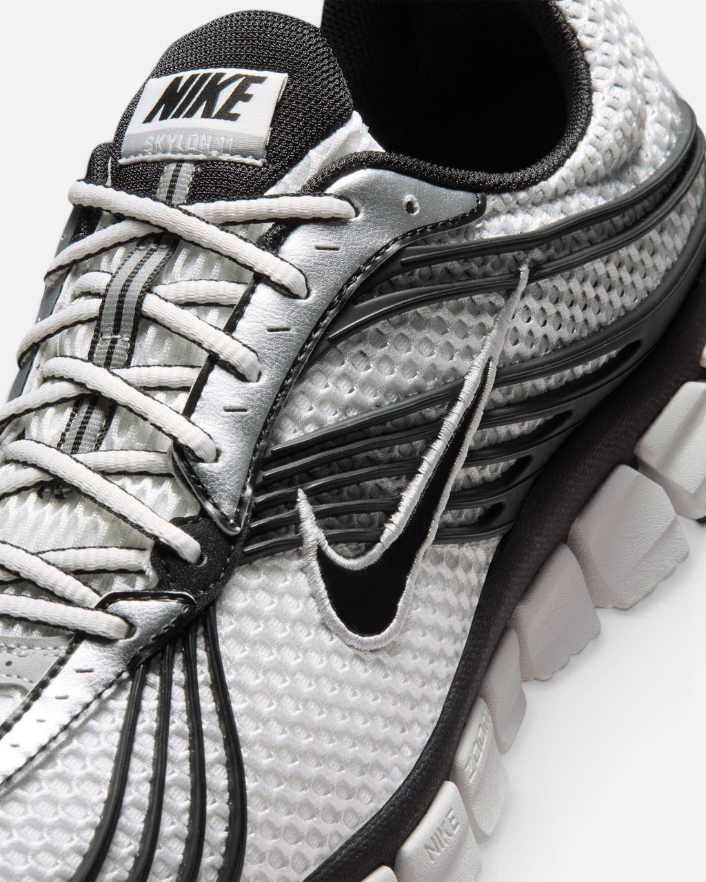 CRIUW Nike Zoom Skylon 11 sneaker in summit white with metallic silver, black accents, and breathable mesh upper.
