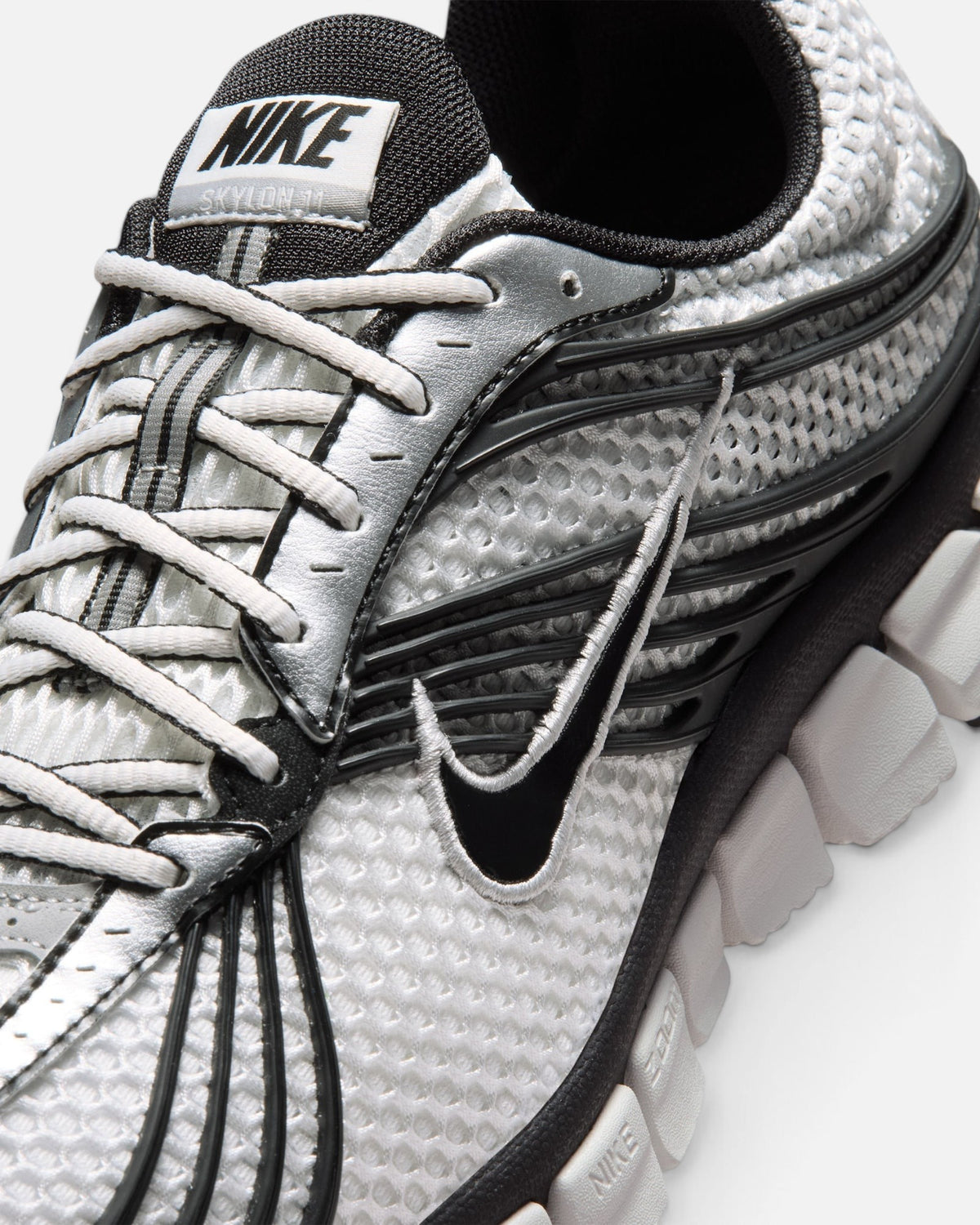 CRIUW Nike Zoom Skylon 11 sneaker in summit white with metallic silver, black accents, and breathable mesh upper.