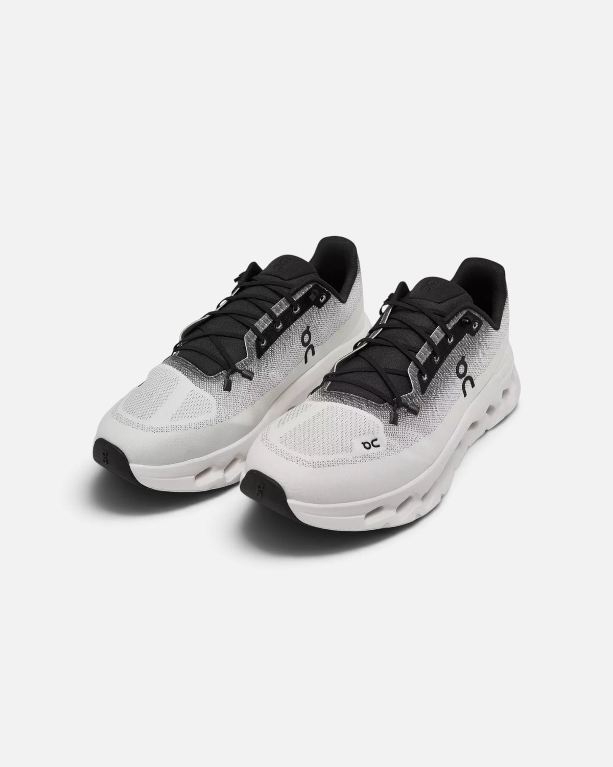 CRIUW On Cloudtilt sneakers in black and ivory with a lightweight mesh upper and cushioned performance sole